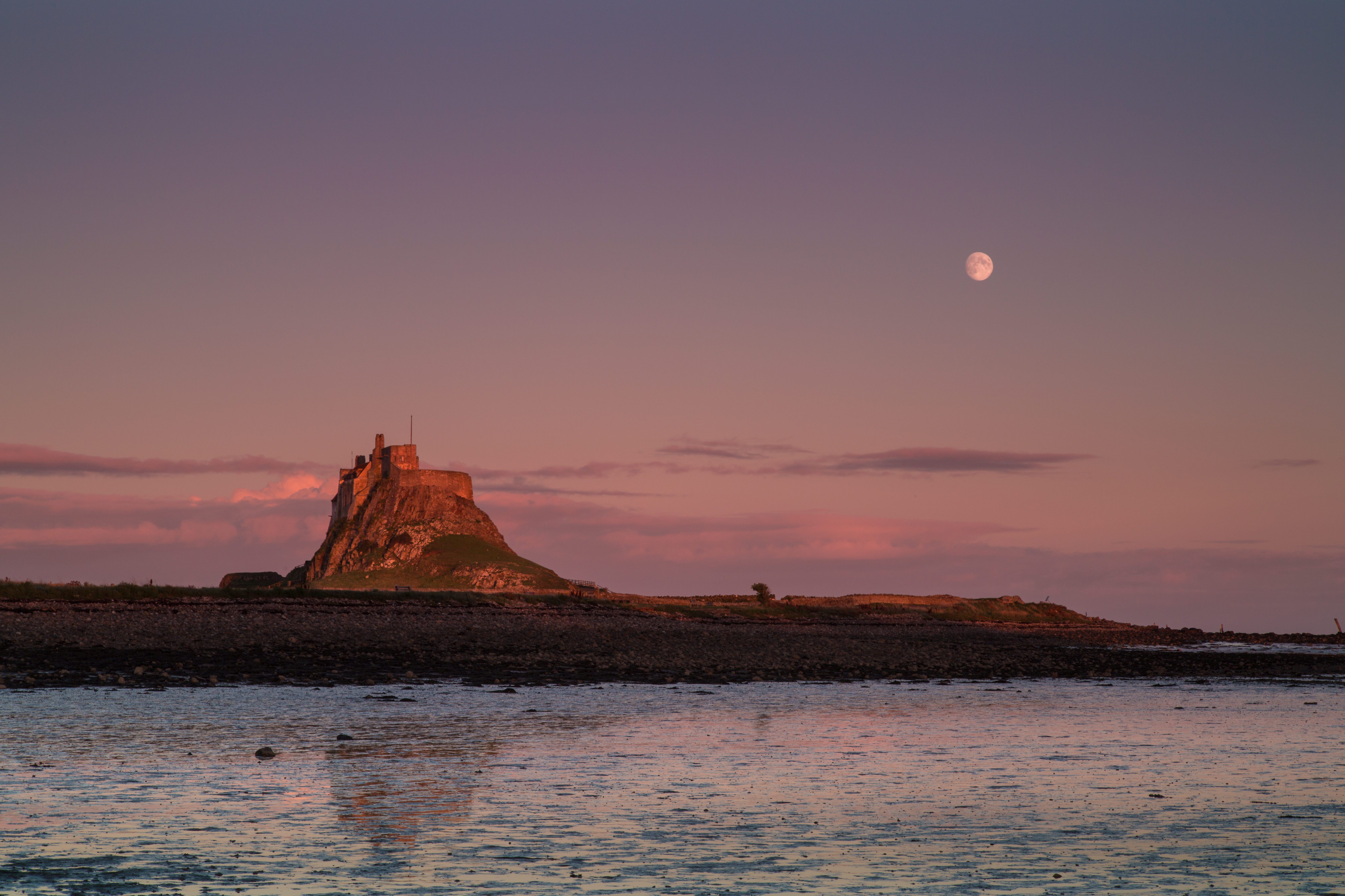 A photo of the moon over Lindisfarne, Northumberland